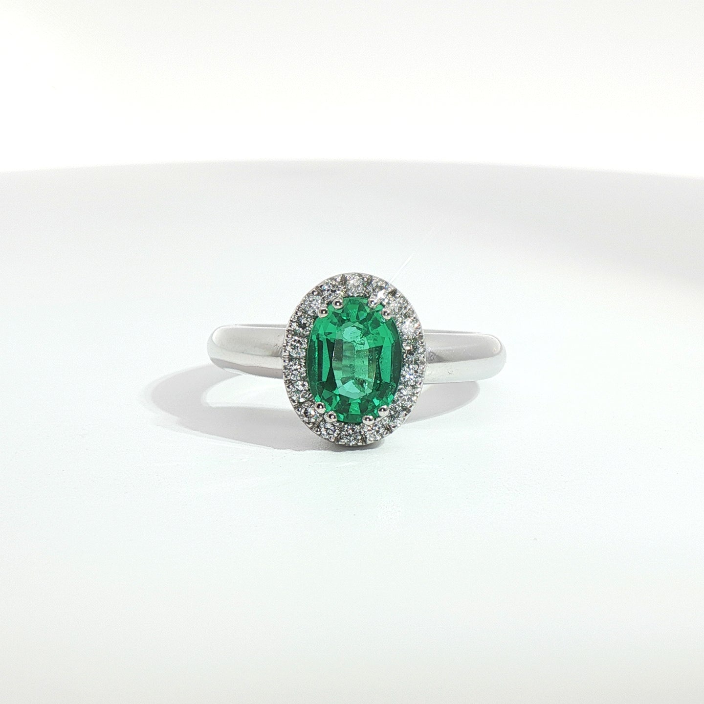 Anello in oro bianco con smeraldo Lab-Grown taglio ovale e diamanti Lab-Grown taglio brillante.