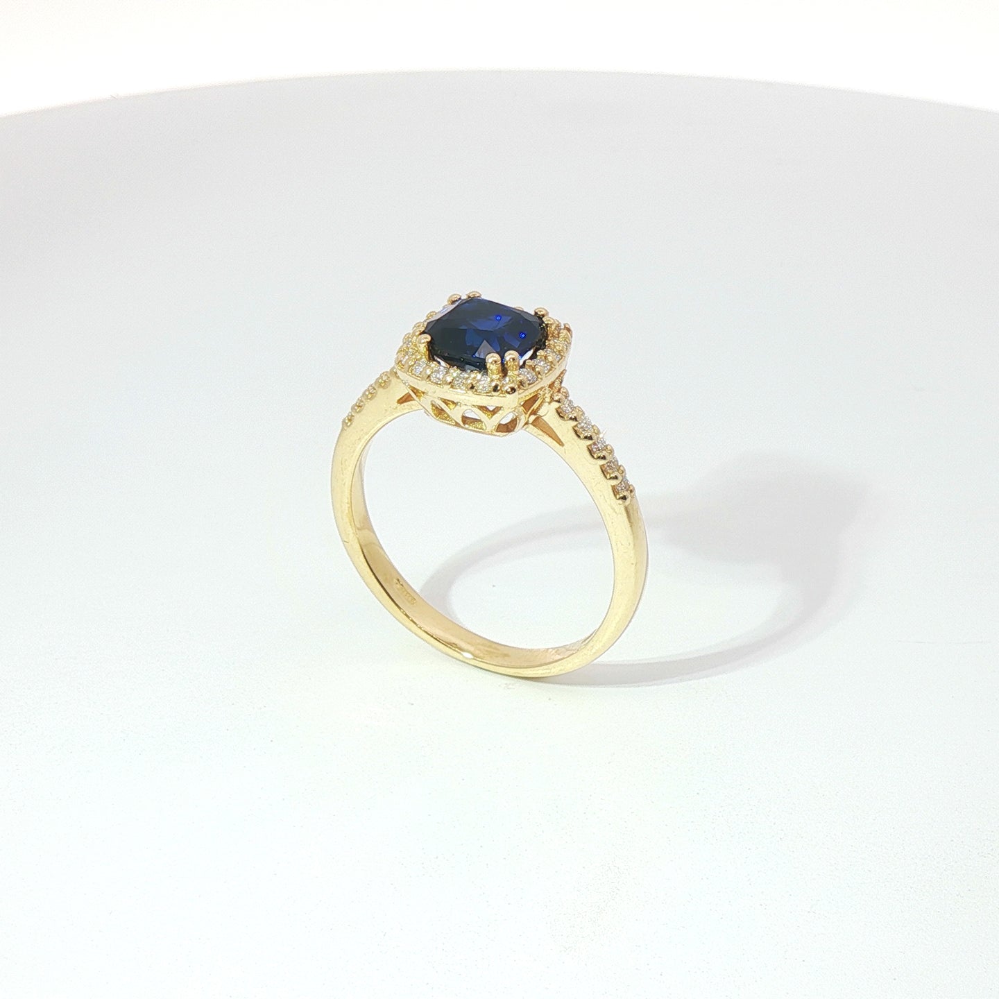 Anello in oro giallo con zaffiro taglio cuscino e diamanti Lab-Grown taglio brillante.